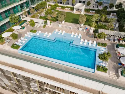 an overhead view of a swimming pool in a building at StoneTree - New Luxury Apartment with Private Beach in Dubai