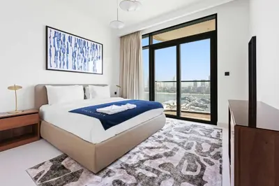 a bedroom with a bed and a large window at Silkhaus The Marina View 2BDR Dubai Harbour in Dubai