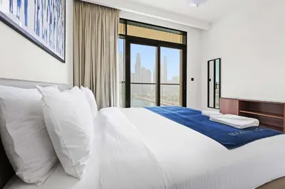 a bedroom with a large white bed with a window at Silkhaus The Marina View 2BDR Dubai Harbour in Dubai