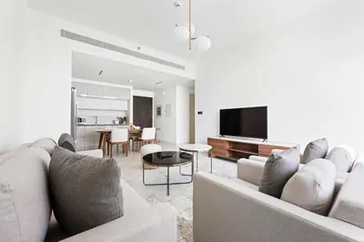 a living room with a couch and a tv at Silkhaus The Marina View 2BDR Dubai Harbour in Dubai