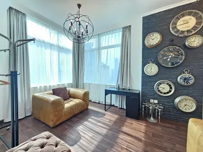 a living room with clocks on the wall at Nice view apartment in Botanica Tower Dubai Marina in Dubai