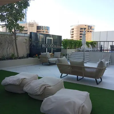 a patio with couches and pillows on a roof at Nice view apartment in Botanica Tower Dubai Marina in Dubai