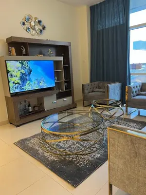 a living room with a tv and a glass table at Spacious Flat in Dubai Downtown in Dubai