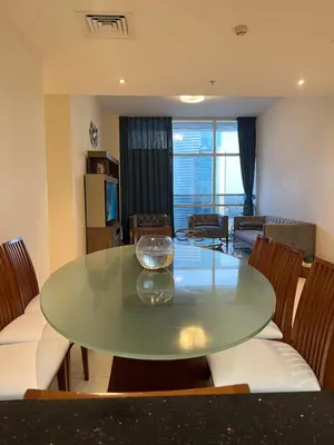 a dining room with a green table and chairs at Spacious Flat in Dubai Downtown in Dubai