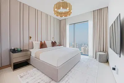 a bedroom with a large bed and a large window at NEW Luxe 3BR in Vida Marina w/ Breathtaking Views in Dubai