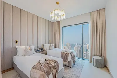 a hotel room with two beds and a window at NEW Luxe 3BR in Vida Marina w/ Breathtaking Views in Dubai