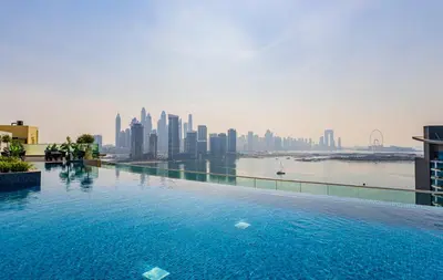 a swimming pool with a view of a city at Luxury Studio, Seven Palm Residence-Palm Jumeirah in Dubai