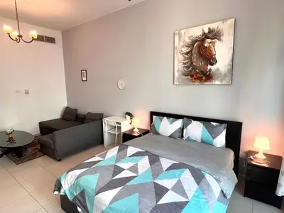 a bedroom with a bed and a painting of a horse at Huge Room in Al Barsha 1 Near Mashreq Metro in Dubai