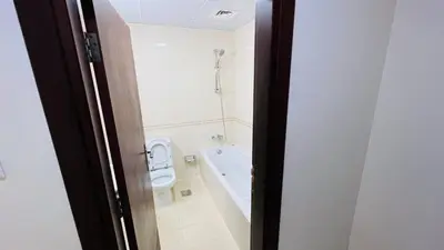 a bathroom with a toilet and a bath tub at Huge Room in Al Barsha 1 Near Mashreq Metro in Dubai