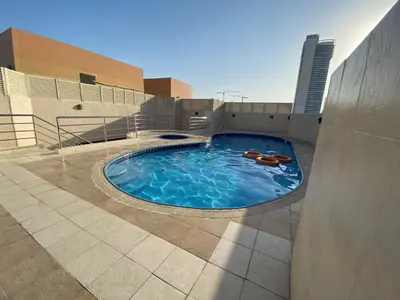 a swimming pool on top of a building at Huge Room in Al Barsha 1 Near Mashreq Metro in Dubai