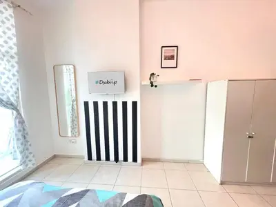 a white room with a black and white door at Huge Room in Al Barsha 1 Near Mashreq Metro in Dubai