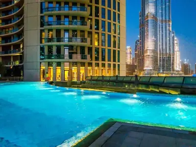 a large swimming pool in a city with tall buildings at FIRST CLASS 3BR with full BURJ KHALIFA and FOUNTAIN VIEW in Dubai