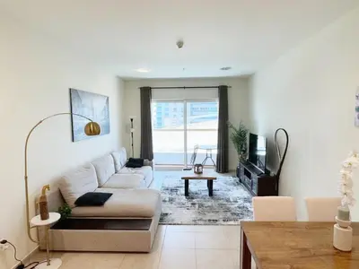 a living room with a couch and a table at Stunning 1 BR Apartment in Dubai Marina in Dubai
