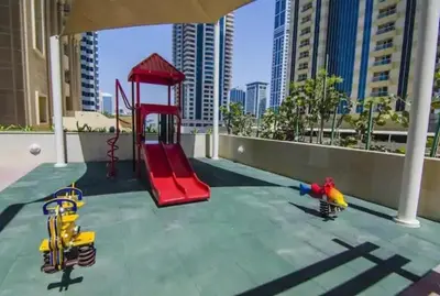 a playground with a red slide at Stunning 1 BR Apartment in Dubai Marina in Dubai