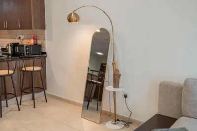 a floor mirror in a living room with a kitchen at Stunning 1 BR Apartment in Dubai Marina in Dubai
