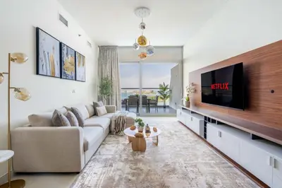 a living room with a couch and a flat screen tv at GuestReady - Glamourous living in Palm Jumeirah in Dubai