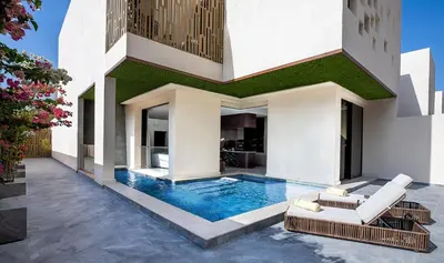 a house with a swimming pool in the yard at The Biltmore Hotel Villas, Dubai in Dubai