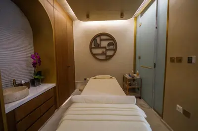 two beds in a bathroom with a sink and a mirror at The Biltmore Hotel Villas, Dubai in Dubai