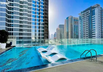 a swimming pool with a view of a building at bnbmehomes - Bayz by Danube in Dubai