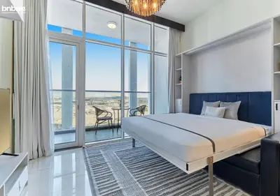 a bedroom with a bed and a large window at bnbmehomes - Bayz by Danube in Dubai