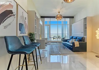a living room with a table and chairs at bnbmehomes - Bayz by Danube in Dubai