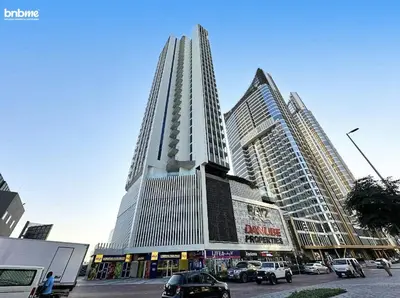 a tall building with cars parked in front of it at bnbmehomes - Bayz by Danube in Dubai