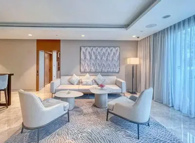 a living room with a couch and chairs and a table at Burj Khalifa view - Modern 1BDR apartment in Dubai