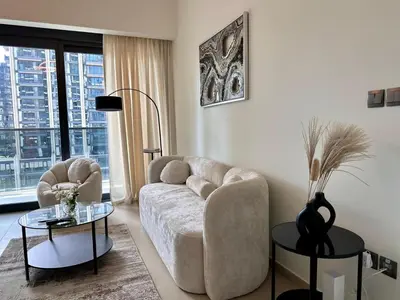 a living room with a couch and a table at Burj Khalifa view - Modern 1BDR apartment in Dubai