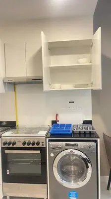 a kitchen with a washing machine and a stove at Best Offer in Dubai hotel apartment damac hills 2 in Dubai