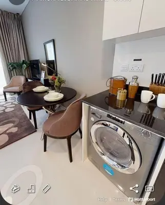 a kitchen with a washing machine and a table at Best Offer in Dubai hotel apartment damac hills 2 in Dubai