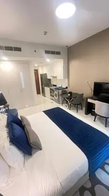 a bedroom with a large bed and a living room at Best Offer in Dubai hotel apartment damac hills 2 in Dubai
