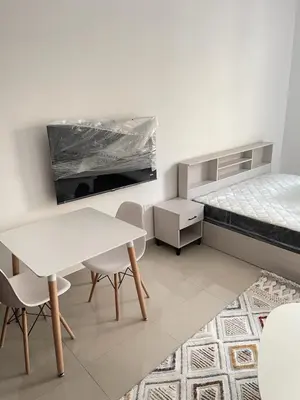 a white room with a table and chairs and a bed at Best Offer in Dubai hotel apartment damac hills 2 in Dubai