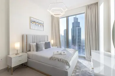 a bedroom with a large bed and a large window at Modern 1 BR with Sea View - Minutes to Dubai Mall, Downtown Dubai in Dubai