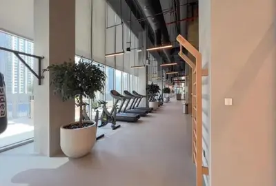 a hallway with a row of potted plants in a building at Modern 1 BR with Sea View - Minutes to Dubai Mall, Downtown Dubai in Dubai