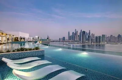 a hotel swimming pool with a view of the city at Modern Fully-Equipped Apartment in Seven Palm, Beach and Pool Access in Dubai