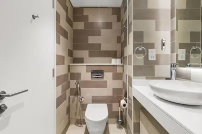a bathroom with a toilet and a sink at Modern Fully-Equipped Apartment in Seven Palm, Beach and Pool Access in Dubai