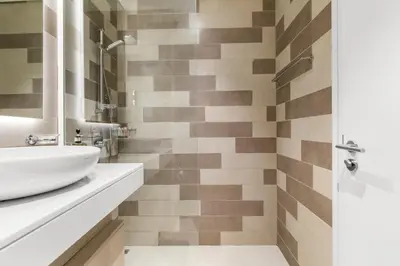a bathroom with a sink and a shower at Modern Fully-Equipped Apartment in Seven Palm, Beach and Pool Access in Dubai