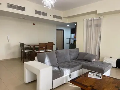 a living room with a couch and a table at AMWAJ JBR Walk Beachfront Apt in Dubai