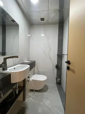 a bathroom with a sink and a toilet and a mirror at AMWAJ JBR Walk Beachfront Apt in Dubai