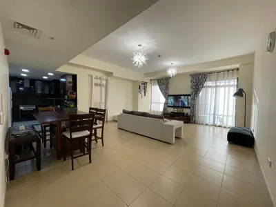 a large living room with a couch and a table at AMWAJ JBR Walk Beachfront Apt in Dubai