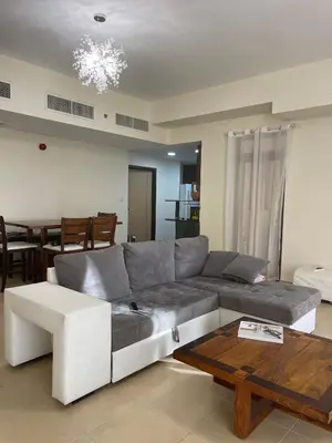a living room with a couch and a table at AMWAJ JBR Walk Beachfront Apt in Dubai