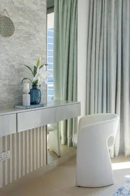 a bathroom with a white chair and a mirror at Frank Porter - Burj Vista 1 in Dubai