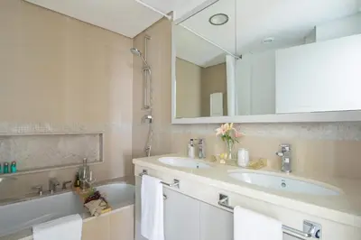 a bathroom with two sinks and a tub and a mirror at Frank Porter - Burj Vista 1 in Dubai