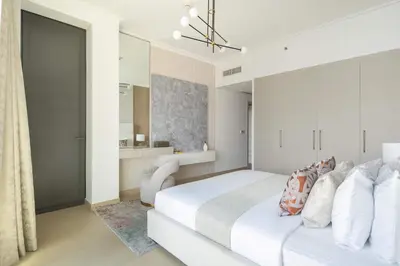 a white bedroom with a white bed and a bathroom at Frank Porter - Burj Vista 1 in Dubai