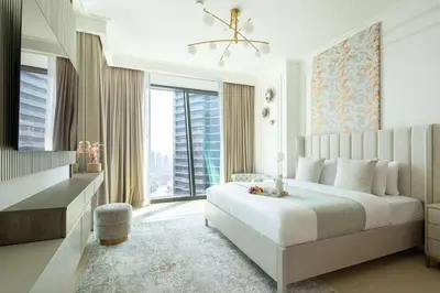 a bedroom with a large bed and a large window at Frank Porter - Burj Vista 1 in Dubai