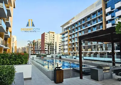 a large building with a swimming pool in front of it at Azizi Riviera 7 - Meydan City, Dubai in Dubai