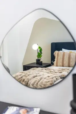 a bedroom with a bed and a mirror at The Smart Concierge - Reehan 8 in Dubai