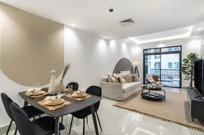 a living room with a table and chairs at The Smart Concierge - Reehan 8 in Dubai