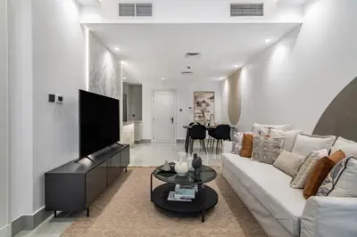 a living room with a couch and a tv at The Smart Concierge - Reehan 8 in Dubai