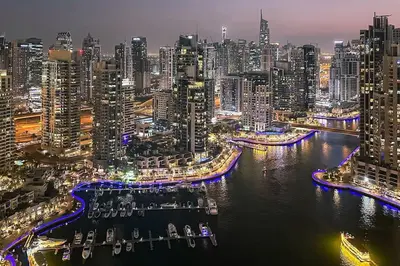 a view of a city at night with boats in the water at 1BDR in Marina Gate Skylineview in Dubai
